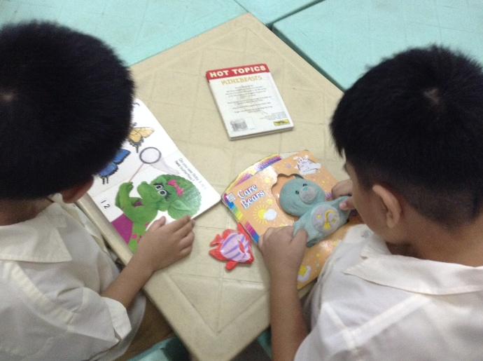 Two young students reading books